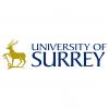 Logo University of Surrey text, golden deer with key 